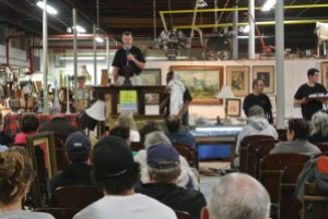 Eager bidders clear the house of items for auction.  For several years in the early 2000s the business was located in the Ruderman's building.