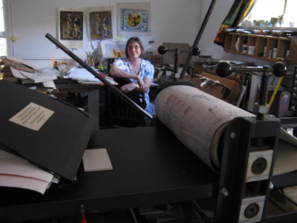 Stephanie Mahan Stigliano in her art studio with printing press
